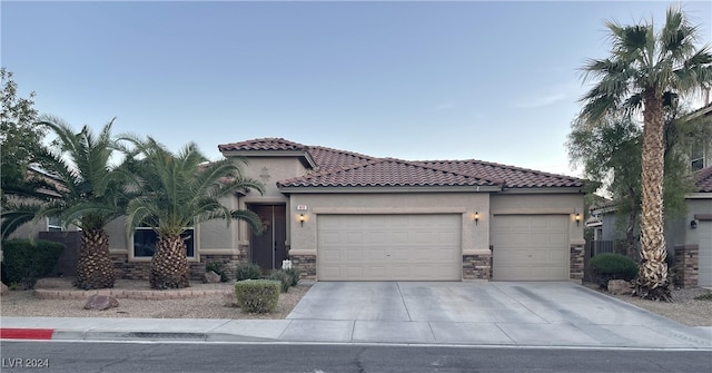 mediterranean / spanish home featuring a garage