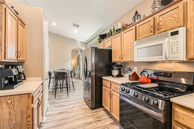 kitchen with stainless steel appliances and light hardwood / wood-style flooring