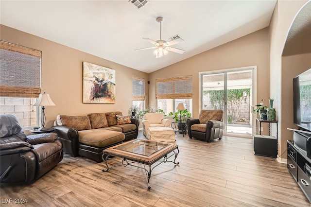 living room featuring ceiling fan, vaulted ceiling, and light wood-type flooring