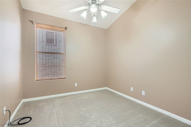 empty room with ceiling fan, light colored carpet, and vaulted ceiling