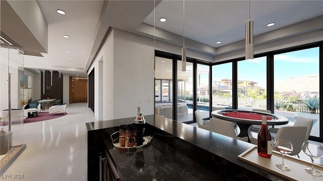 interior space featuring hanging light fixtures and dark stone counters