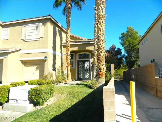 exterior space with a garage and a front lawn