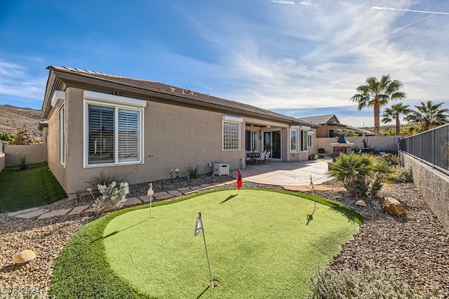 back of property with a patio