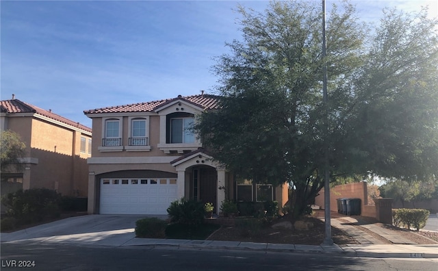 mediterranean / spanish-style home with a garage