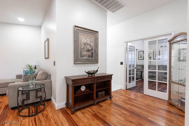 hall featuring french doors and hardwood / wood-style flooring