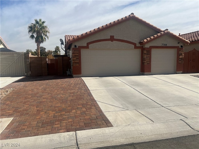 mediterranean / spanish-style house with a garage