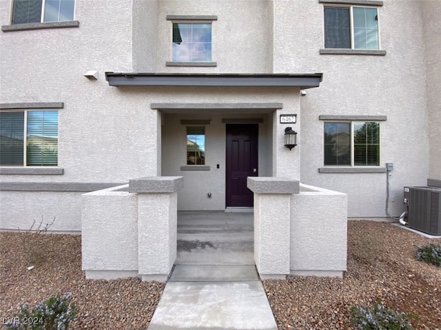 property entrance featuring central AC unit