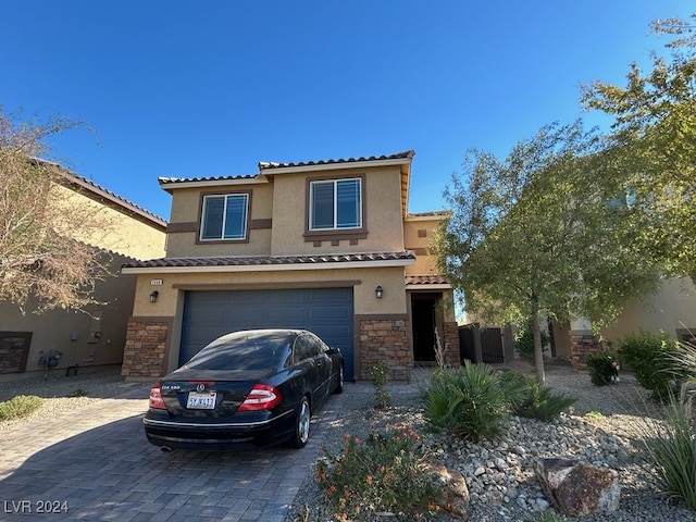 mediterranean / spanish house featuring a garage