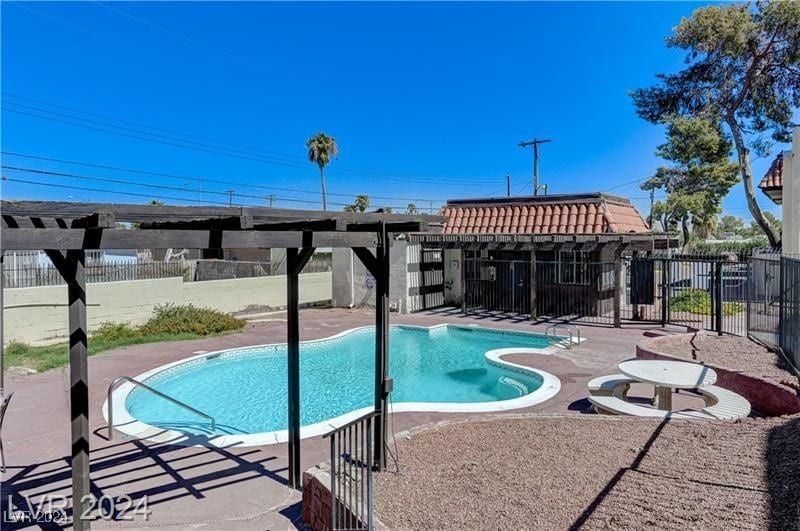 view of swimming pool with a patio