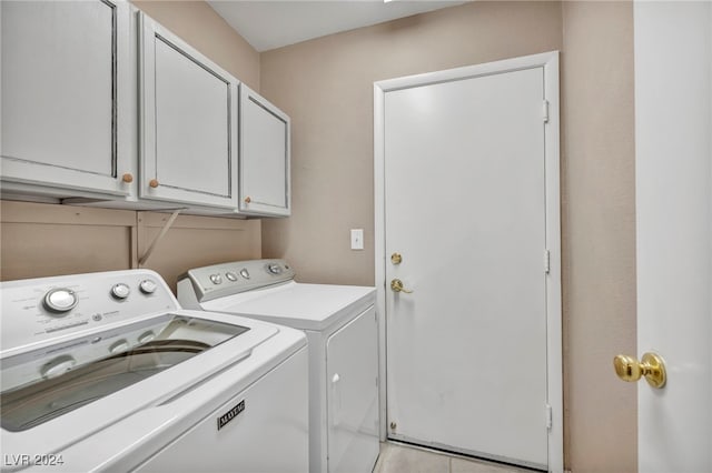 laundry area with washer and dryer and cabinets