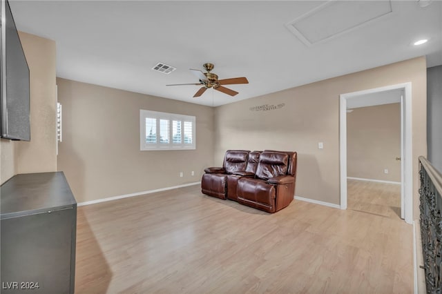 living room featuring ceiling fan and light hardwood / wood-style floors