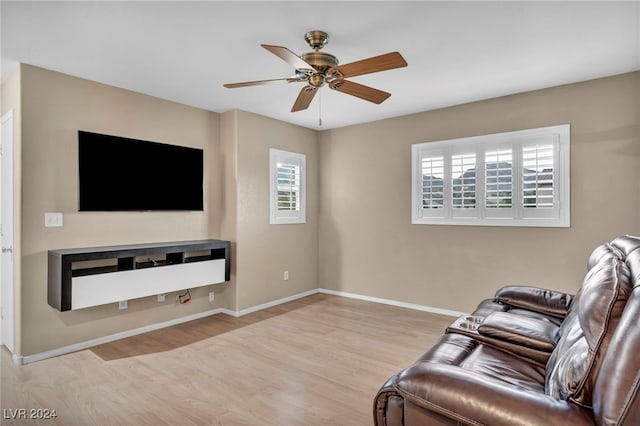 living room with ceiling fan and light wood-type flooring