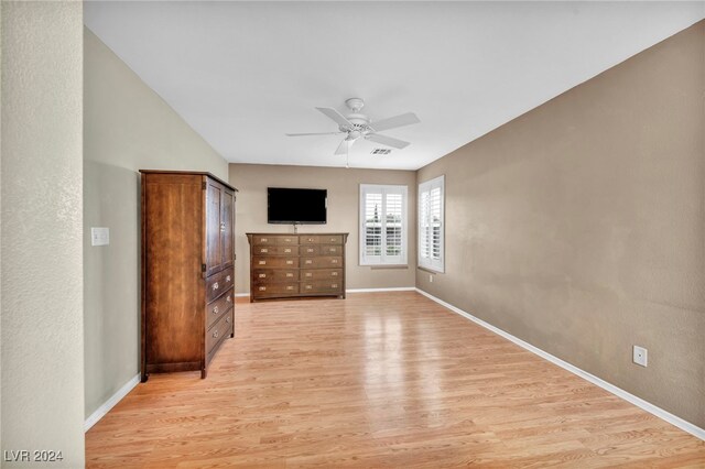 unfurnished bedroom with ceiling fan and light hardwood / wood-style floors