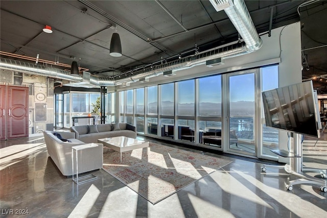 living room with plenty of natural light and concrete flooring