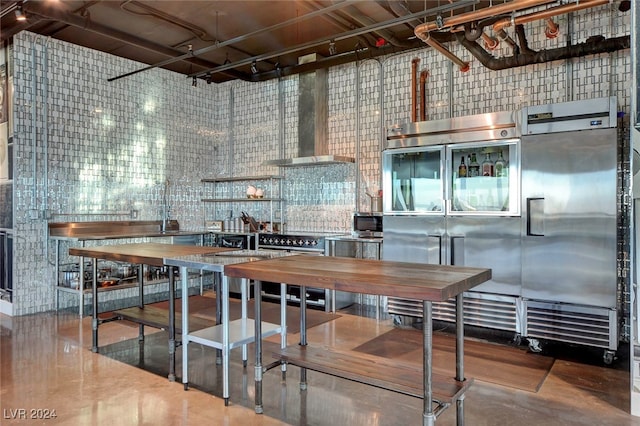 kitchen featuring concrete floors and high quality appliances