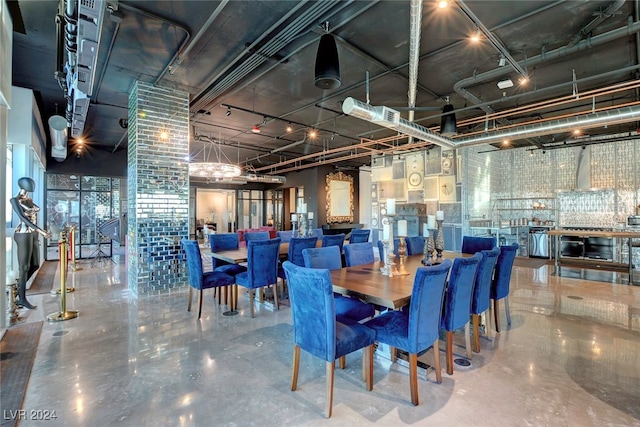 dining space featuring concrete floors