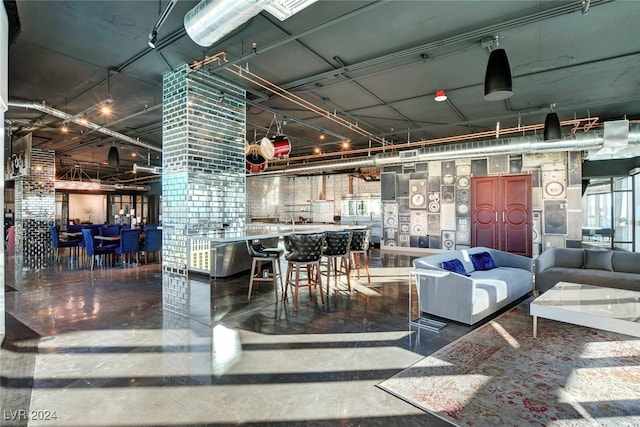 interior space with concrete floors and indoor bar