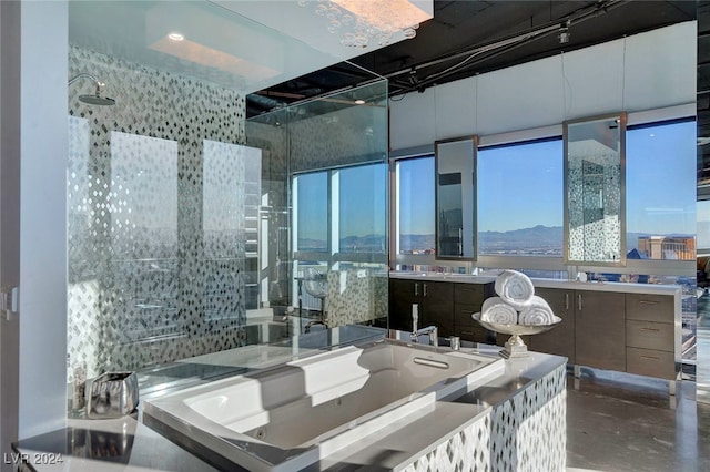 interior space with vanity, a wealth of natural light, a bath, and concrete flooring