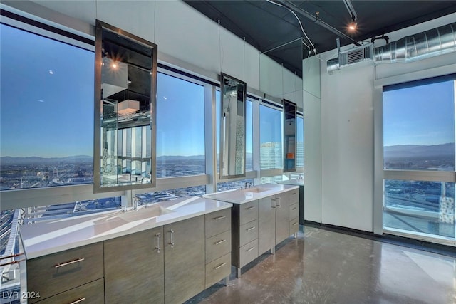 bathroom with a mountain view, vanity, and concrete floors