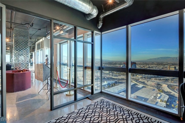 interior space with concrete floors and floor to ceiling windows