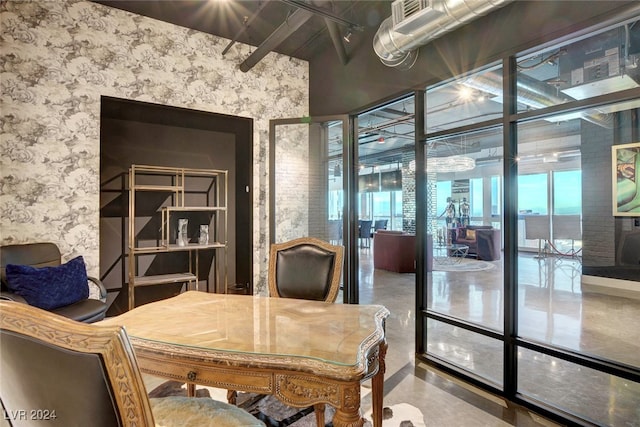 office with floor to ceiling windows and concrete floors