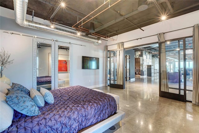 bedroom featuring concrete floors and french doors