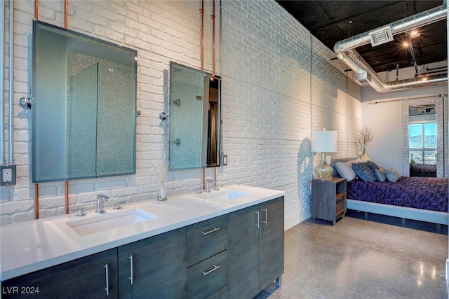 bathroom with concrete floors, vanity, brick wall, and walk in shower