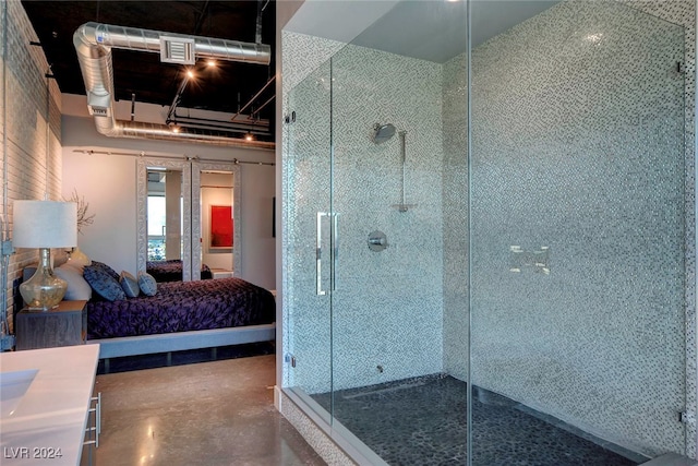 bathroom featuring vanity, concrete floors, and walk in shower