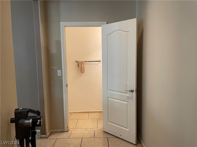 corridor featuring light tile patterned floors