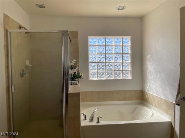 bathroom with separate shower and tub