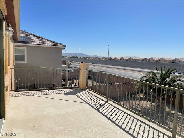 view of patio / terrace with a mountain view and a balcony