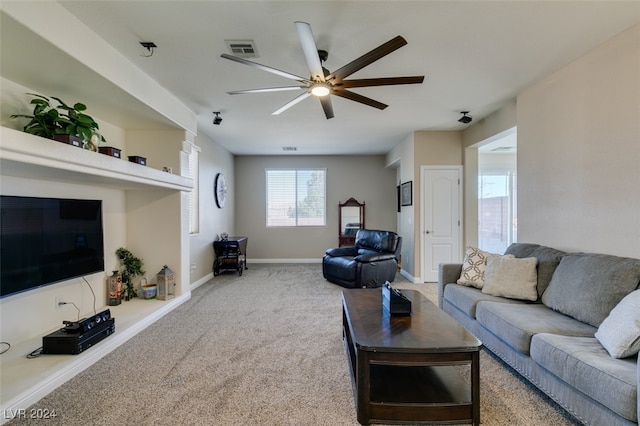 living room featuring ceiling fan and carpet