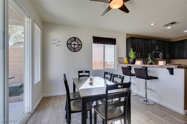 dining area featuring ceiling fan and light hardwood / wood-style floors