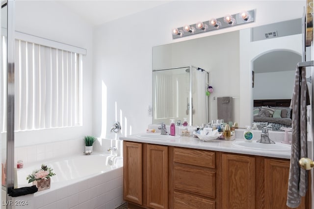 bathroom featuring vanity and shower with separate bathtub