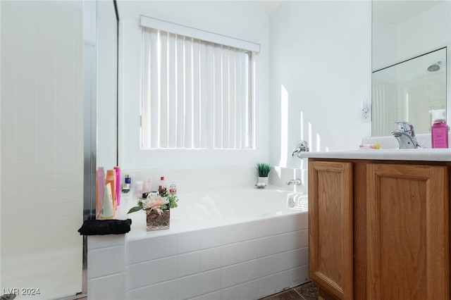 bathroom with vanity and independent shower and bath