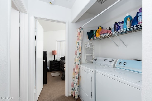 clothes washing area featuring carpet floors and washer and dryer