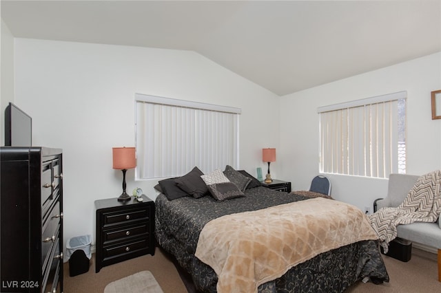 carpeted bedroom with lofted ceiling