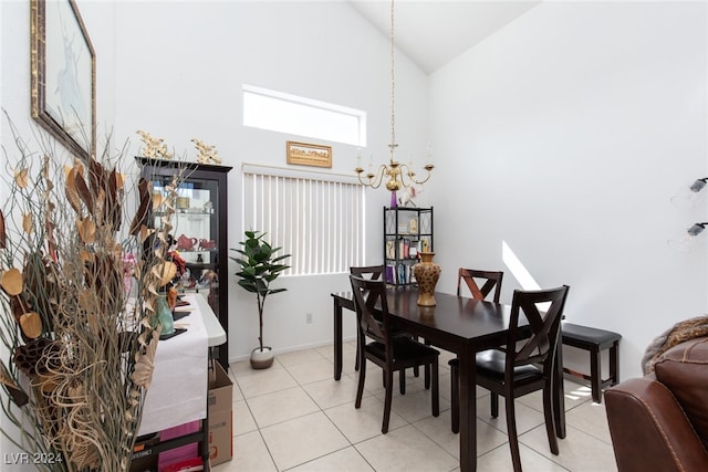 tiled dining space with high vaulted ceiling and an inviting chandelier