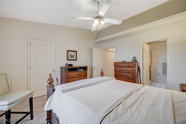 carpeted bedroom featuring connected bathroom and ceiling fan