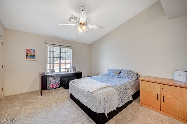 bedroom with light carpet, vaulted ceiling, and ceiling fan