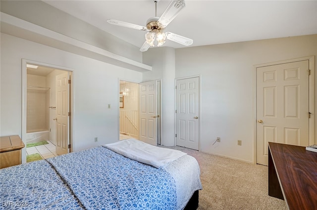 bedroom featuring light carpet, connected bathroom, ceiling fan, and lofted ceiling