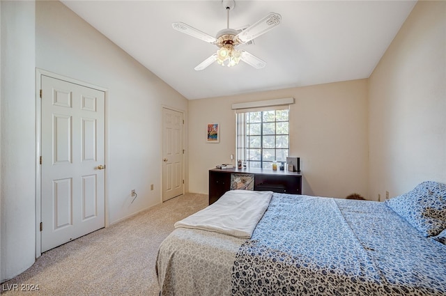 bedroom with ceiling fan, lofted ceiling, and light colored carpet