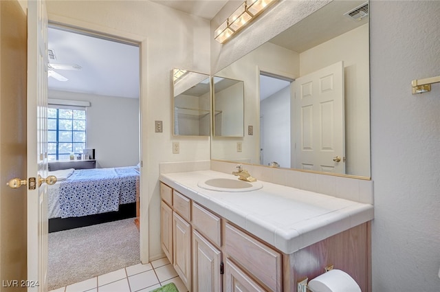 bathroom with ceiling fan, tile patterned flooring, and vanity