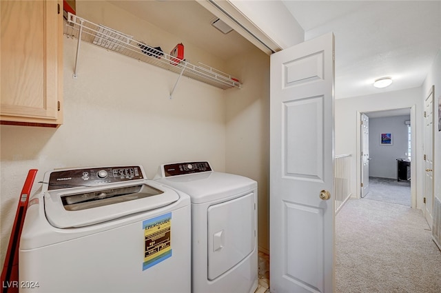 laundry area with washer and clothes dryer and light carpet