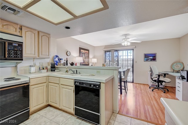 kitchen featuring range with electric stovetop, black dishwasher, kitchen peninsula, ceiling fan, and light wood-type flooring