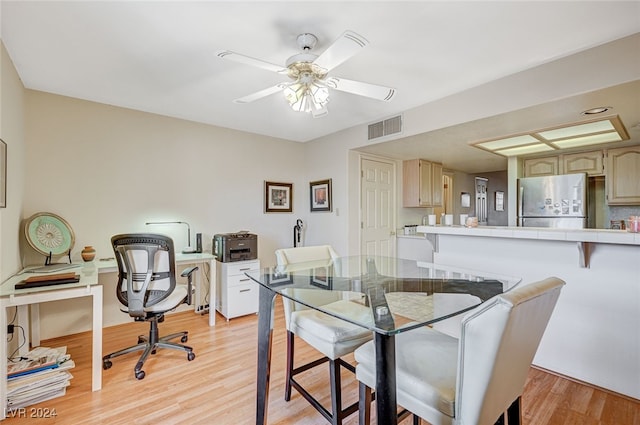 dining space with ceiling fan and light hardwood / wood-style floors