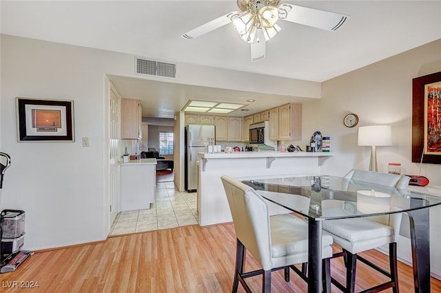 dining room featuring light wood-type flooring and ceiling fan