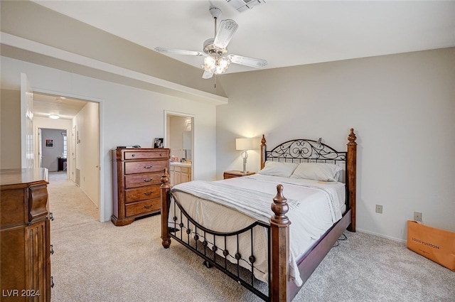 carpeted bedroom featuring ensuite bathroom and ceiling fan