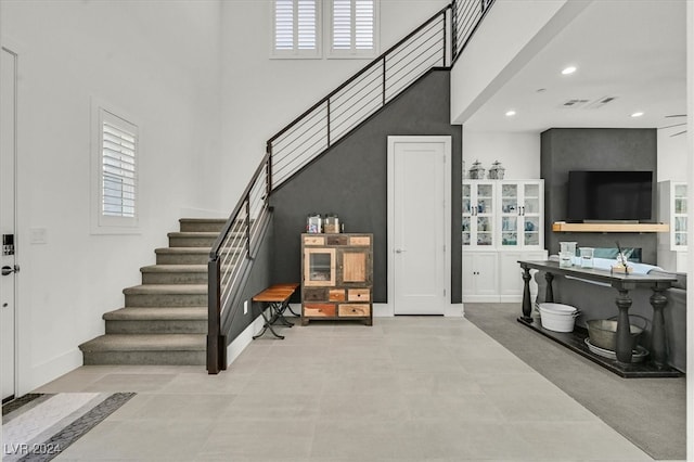 interior space featuring a high ceiling and plenty of natural light