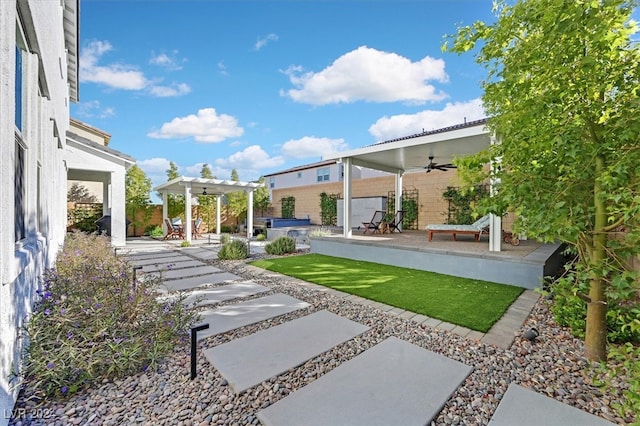 view of yard featuring ceiling fan, a pergola, and a patio area